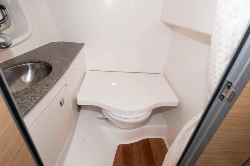 Slide: The Image of 2013 Chaparral 327 SSX boat bathroom with sink and toilet. - 17