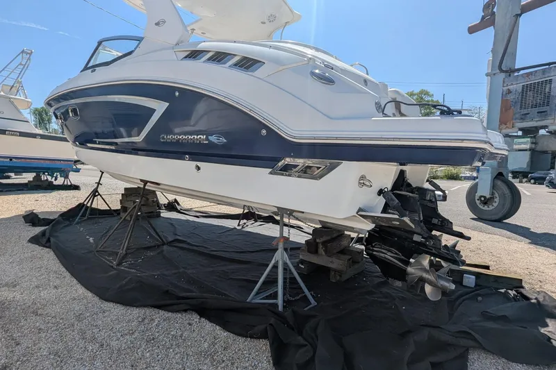 Slide: The Image of 2013 Chaparral 327 SSX boat on stands, displayed outdoors. - 21