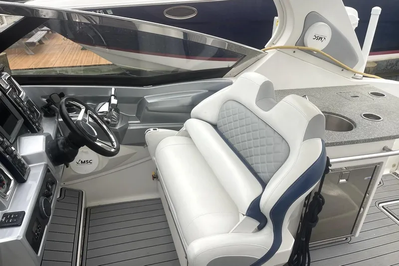 Slide: The Image of 2013 Chaparral 327 SSX boat interior with steering wheel and seating area. - 4