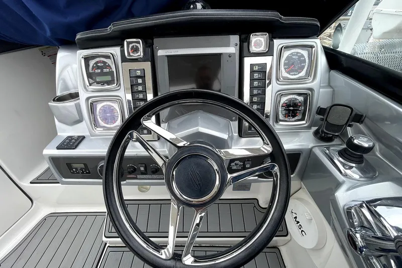 Slide: The Image of Cockpit of 2013 Chaparral 327 SSX boat with steering wheel and control panel. - 5