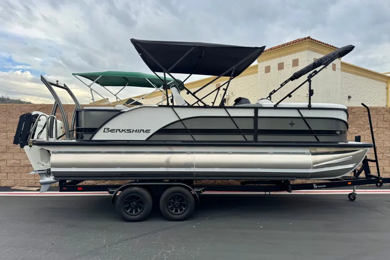 The Image of 2026 Berkshire 21CL STS pontoon boat on trailer, featuring dual canopies. - 0