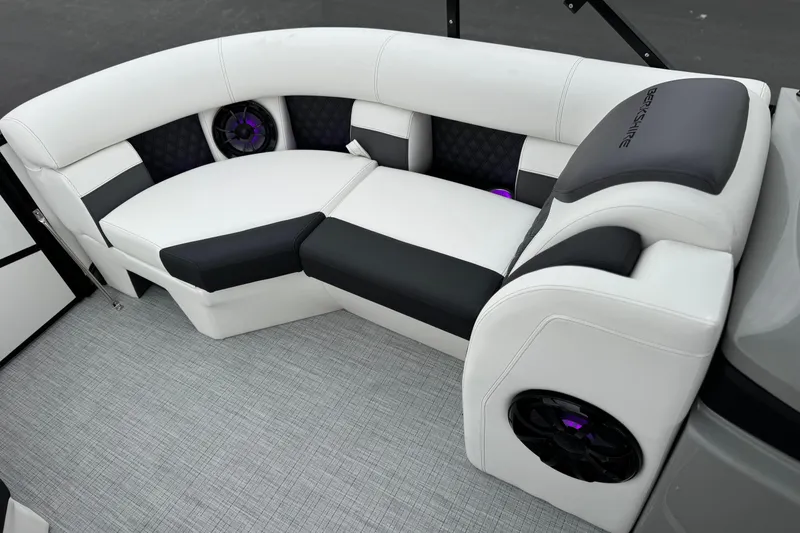 Slide: The Image of Luxurious seating in the 2026 Berkshire 21CL STS boat with modern design and integrated speakers. - 13