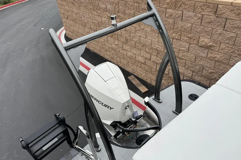 Slide: The Image of 2026 Berkshire 21CL STS boat with Mercury outboard motor, docked near a brick wall. - 22