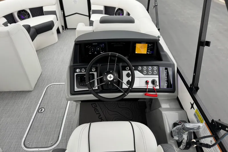 Slide: The Image of 2026 Berkshire 21CL STS boat interior with modern steering console and seating. - 26