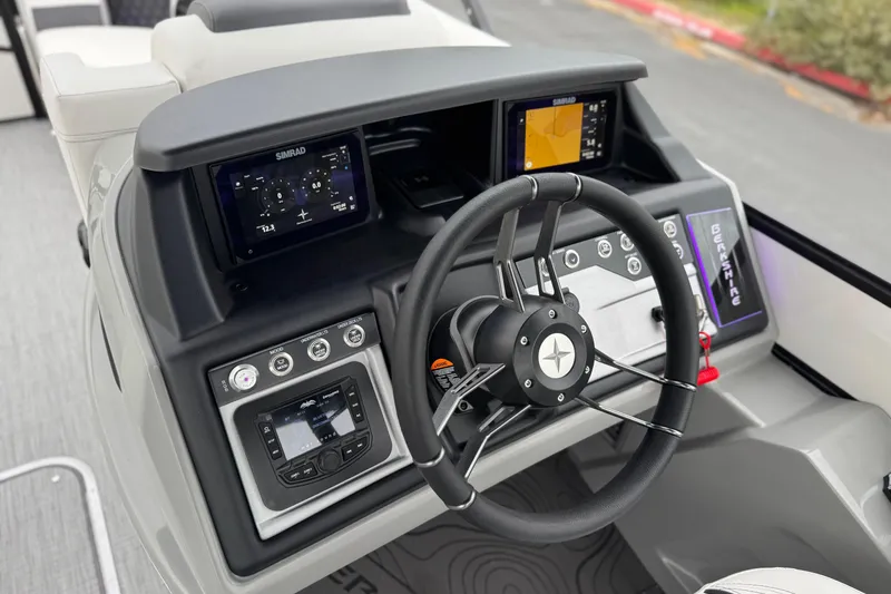 Slide: The Image of 2026 Berkshire 21CL STS boat dashboard with steering wheel and digital displays. - 27