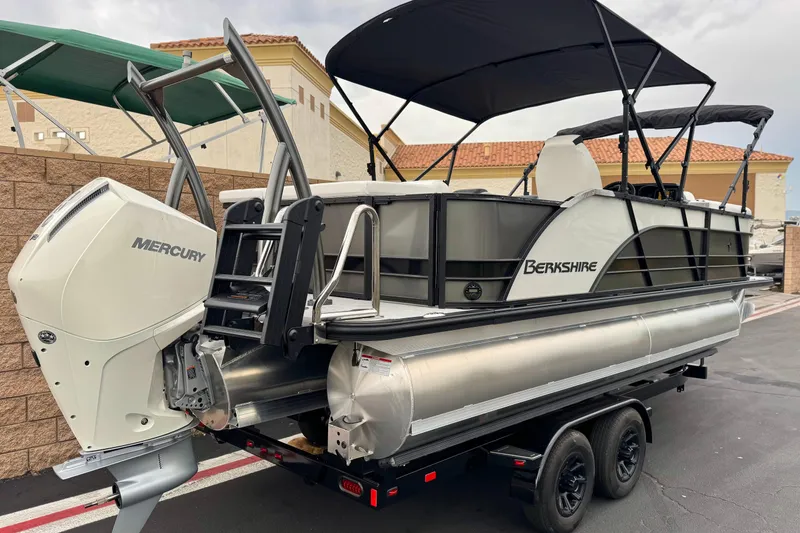 Slide: The Image of 2026 Berkshire 21CL STS pontoon boat with Mercury engine, parked on a trailer. - 6