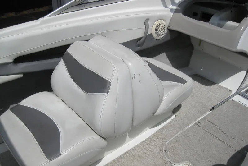 Slide: The Image of 2005 Maxum 1900 SR3 boat interior with white and gray seating and steering wheel. - 10