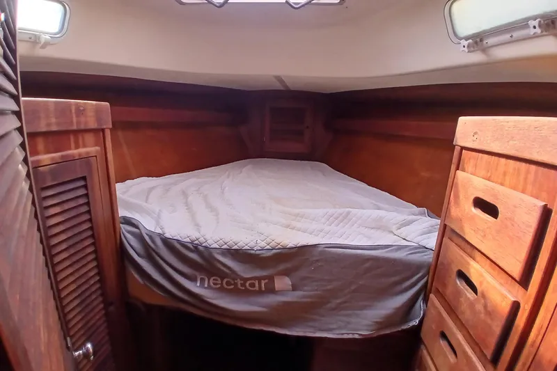 Slide: The Image of Cozy cabin interior of a 1977 Tartan 37 sailboat with wooden furnishings. - 12