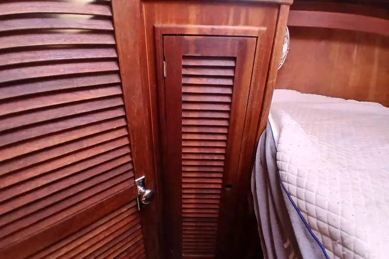 Slide: The Image of Wooden interior of 1977 Tartan 37 sailboat with louvered cabinet and bed. - 15