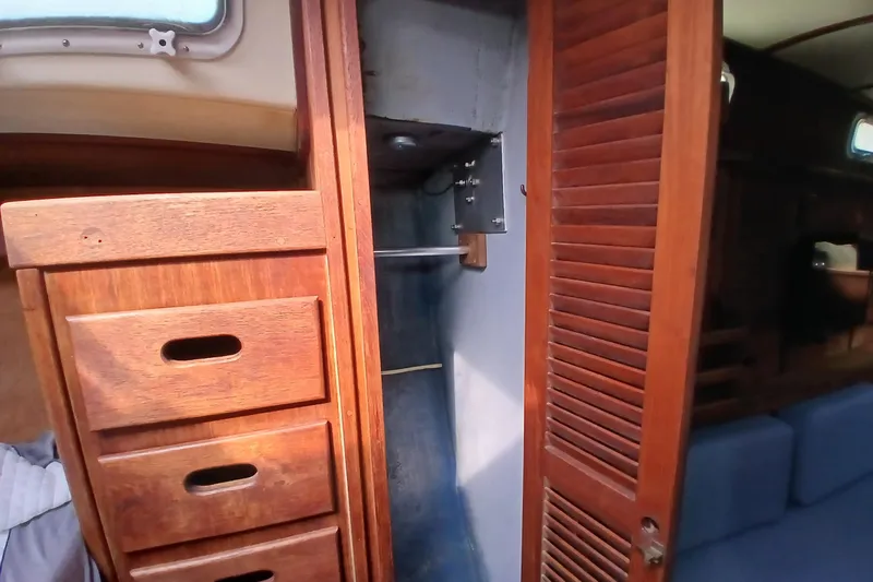 Slide: The Image of Interior of a 1977 Tartan 37 sailboat showing wooden drawers and closet space. - 18
