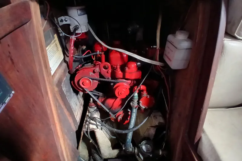 Slide: The Image of Engine compartment of a 1977 Tartan 37 sailboat, featuring a red engine. - 26