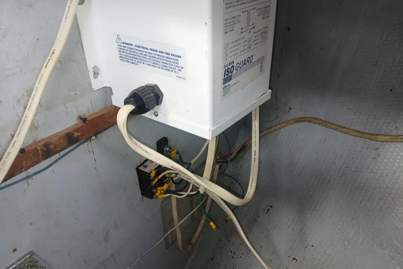 Slide: The Image of Electrical setup in a 1977 Tartan 37 boat, featuring IsoGuard system and wiring. - 34