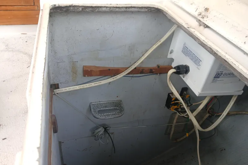 Slide: The Image of Electrical compartment of a 1977 Tartan 37 sailboat with wiring and equipment. - 35