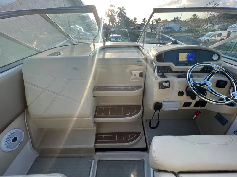 Slide: The Image of 2020 Regal 26 XO boat cockpit with steering wheel and dashboard controls. - 13
