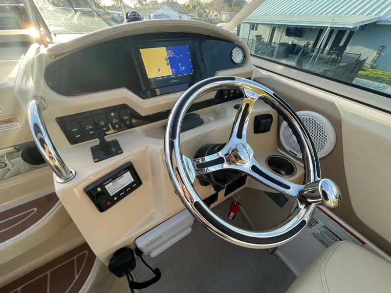 Slide: The Image of 2020 Regal 26 XO boat dashboard with steering wheel and navigation display. - 15