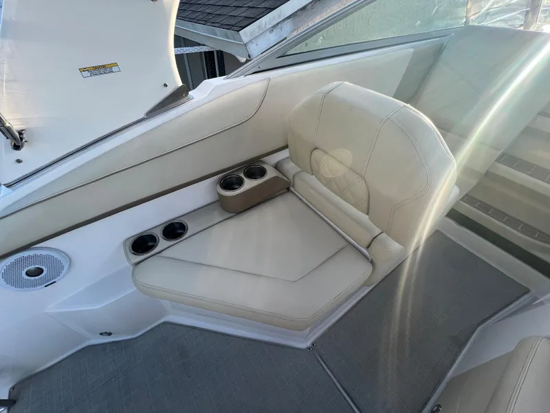 Slide: The Image of 2020 Regal 26 XO boat interior with beige seating and cup holders. - 20