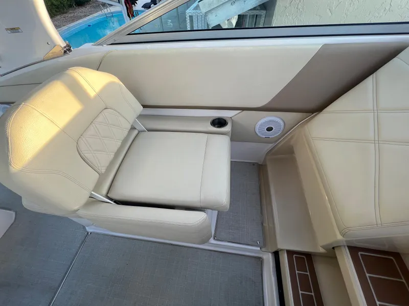 Slide: The Image of 2020 Regal 26 XO boat interior with beige seating and cup holder. - 23