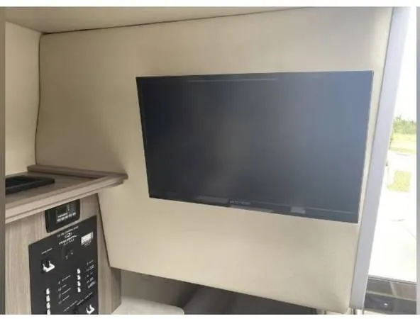 Slide: The Image of Interior of 2020 Regal 26 XO boat featuring a mounted flat-screen TV. - 40