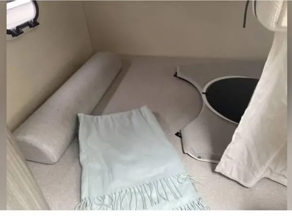 Slide: The Image of 2020 Regal 26 XO cabin interior with cushions and a light blue blanket. - 43