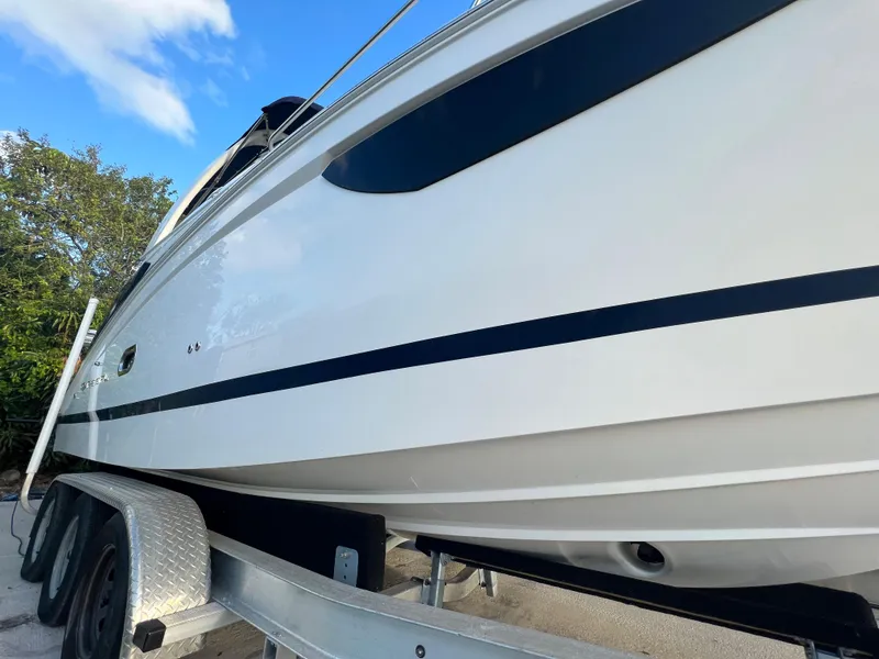 Slide: The Image of 2020 Regal 26 XO boat on trailer, side view under blue sky. - 6