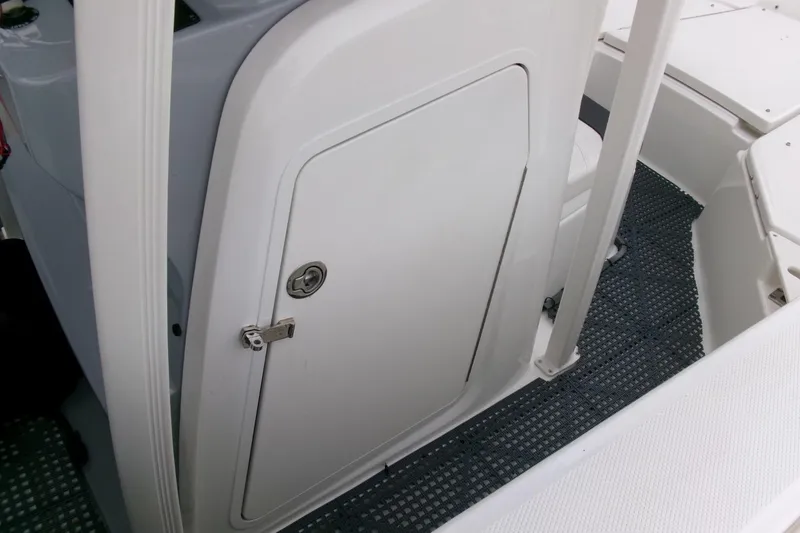 Slide: The Image of 2023 Bayliner Trophy T20CC boat interior with storage compartment door. - 12