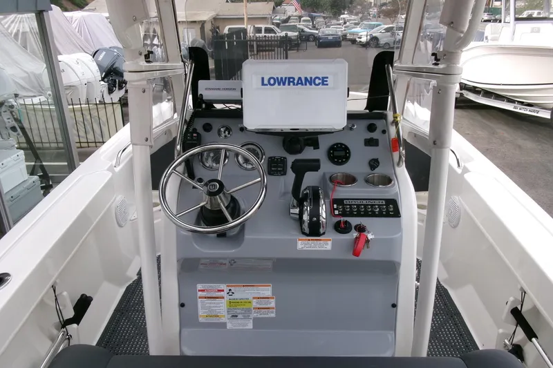 Slide: The Image of 2023 Bayliner Trophy T20CC boat console with steering wheel and navigation equipment. - 14