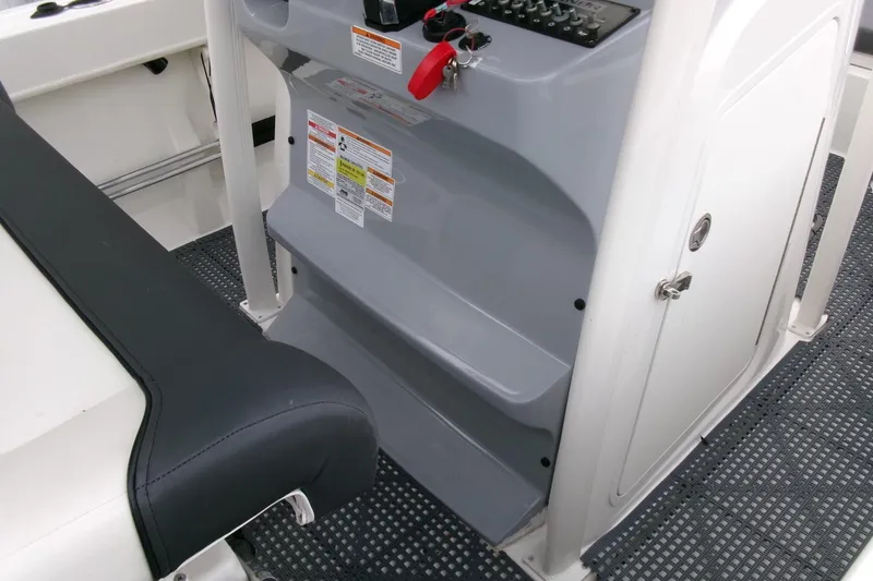 Slide: The Image of 2023 Bayliner Trophy T20CC boat interior with console and seating details. - 15