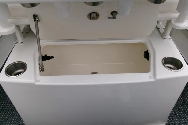 Slide: The Image of 2023 Bayliner Trophy T20CC boat storage compartment with cup holders and latch. - 19