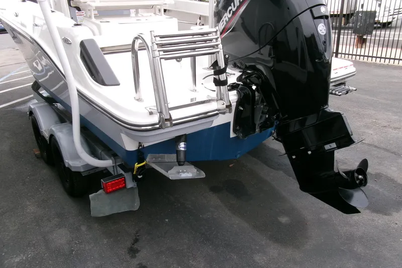 Slide: The Image of 2023 Bayliner Trophy T20CC boat with outboard motor and trailer, rear view. - 25
