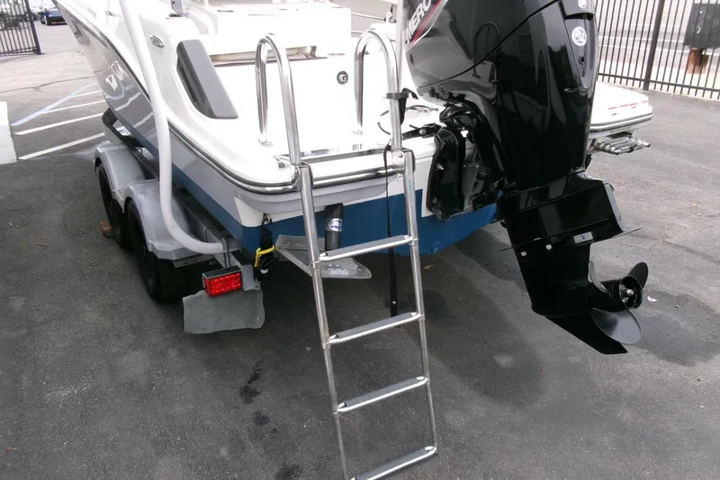 Slide: The Image of 2023 Bayliner Trophy T20CC boat with outboard motor and trailer, rear view. - 26