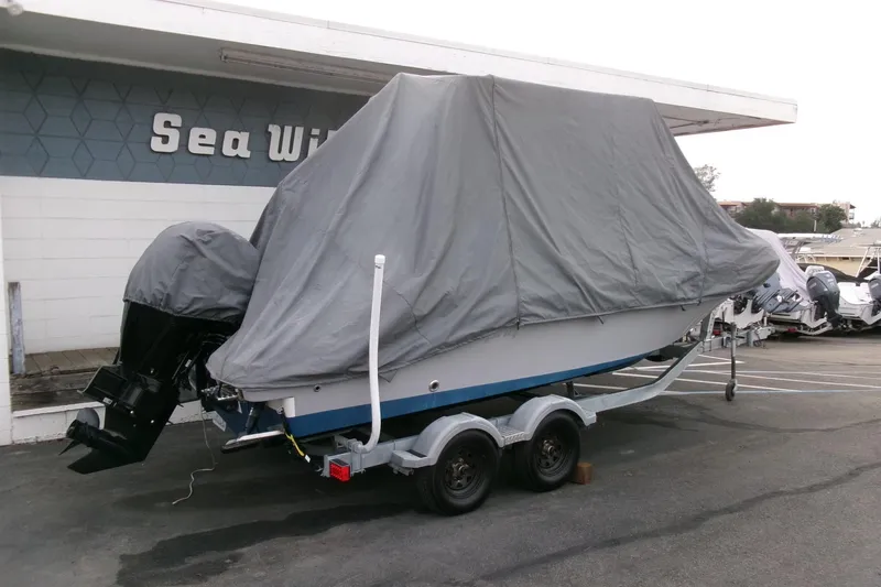 Slide: The Image of 2023 Bayliner Trophy T20CC boat covered on trailer at Sea Wise dealership. - 30