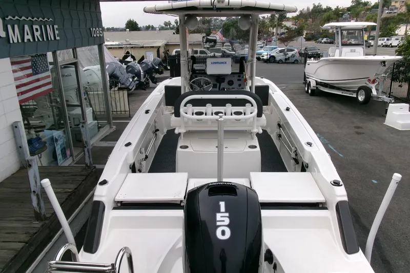 Slide: The Image of 2023 Bayliner Trophy T20CC boat with Mercury 150 engine at a marina display. - 32