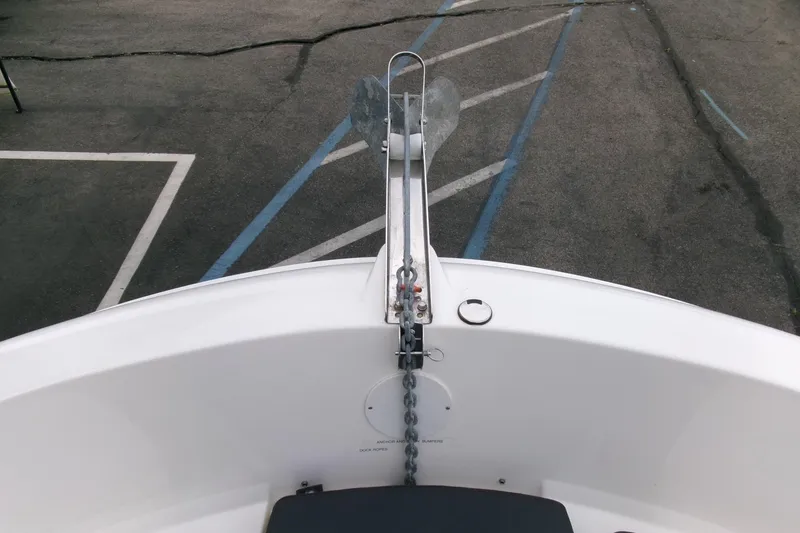 Slide: The Image of 2023 Bayliner Trophy T20CC boat anchor and chain on deck, parked on asphalt. - 4