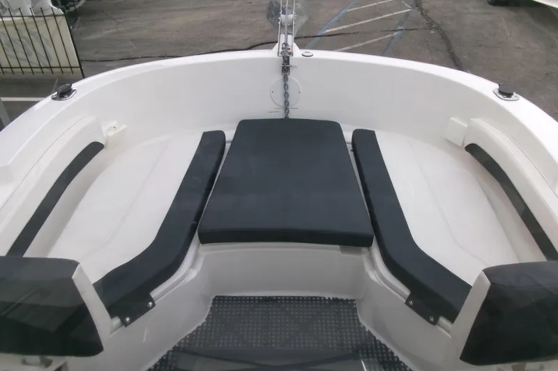 Slide: The Image of 2023 Bayliner Trophy T20CC boat interior with cushioned seating and anchor chain. - 5