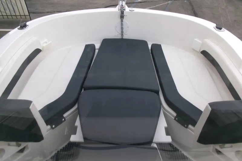 Slide: The Image of 2023 Bayliner Trophy T20CC boat interior with cushioned seating arrangement. - 6