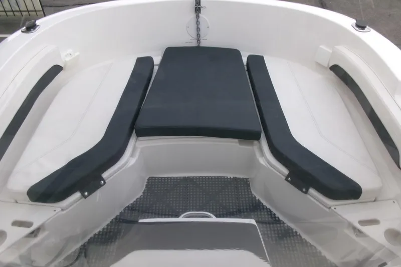 Slide: The Image of 2023 Bayliner Trophy T20CC boat interior with cushioned seating area. - 7