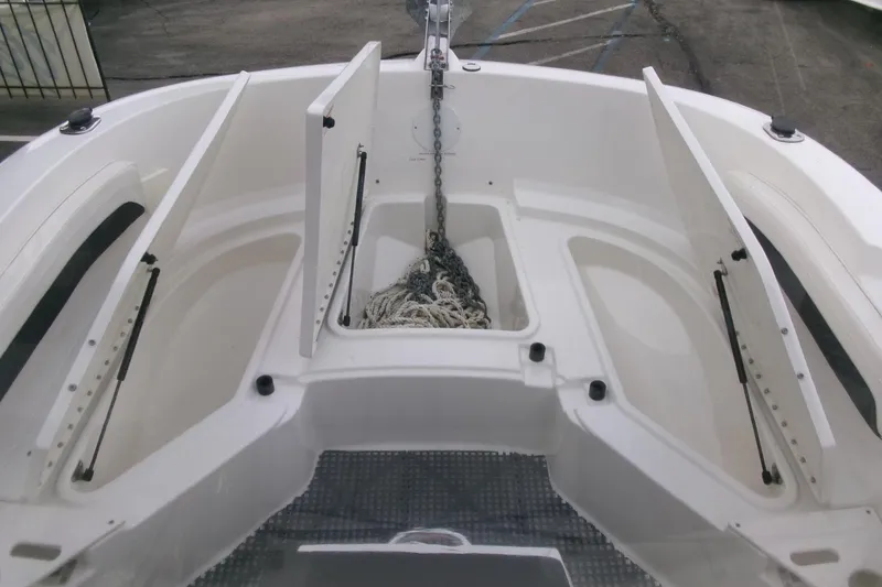 Slide: The Image of 2023 Bayliner Trophy T20CC boat anchor storage compartment with open hatches. - 9