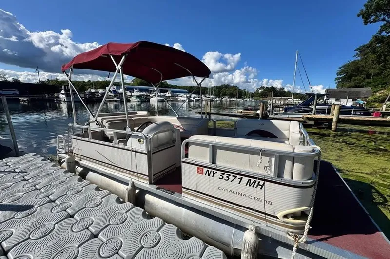 The Image of 2008 Avalon Catalina 18' pontoon boat docked on a sunny day. - 0