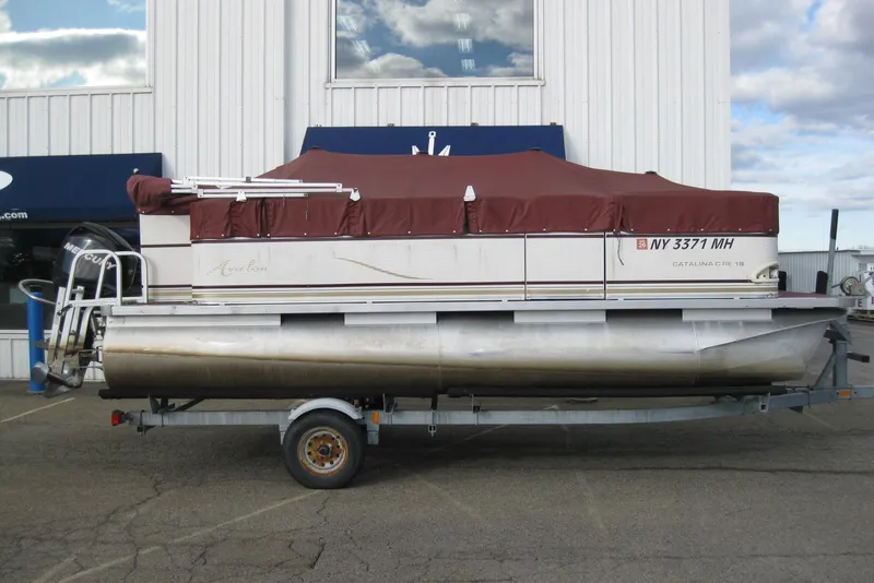 Slide: The Image of 2008 Avalon Catalina 18' pontoon boat on trailer with maroon cover. - 10