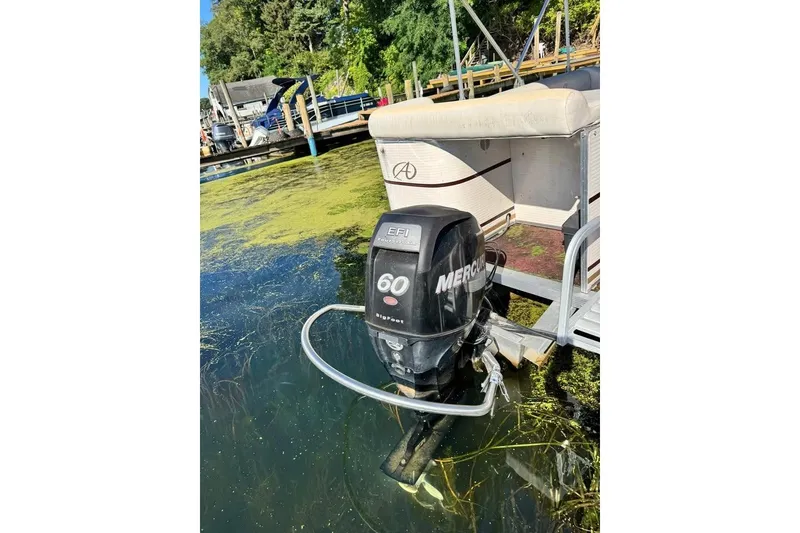 Slide: The Image of 2008 Avalon Catalina 18' pontoon boat with Mercury 60 EFI outboard motor at dock. - 3