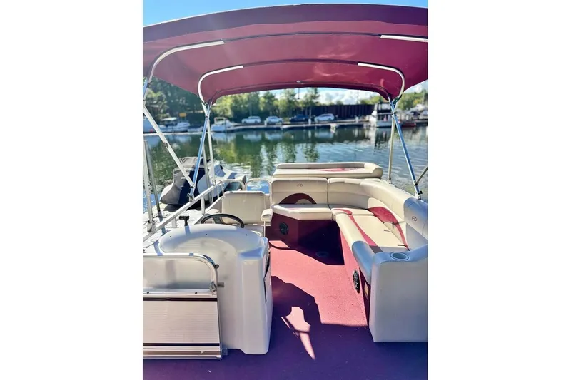 Slide: The Image of 2008 Avalon Catalina 18' pontoon boat with red canopy on a sunny lake. - 4