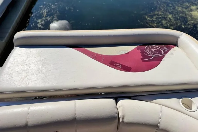 Slide: The Image of 2008 Avalon Catalina boat seat with maroon design, docked by the water. - 7