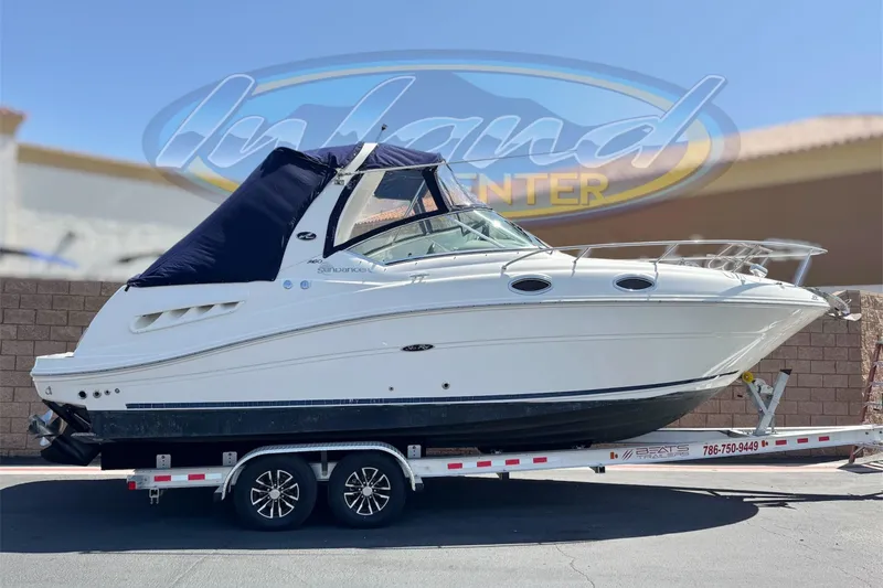 The Image of 2006 Sea Ray Sundancer 260 boat on trailer, displayed outdoors. - 0
