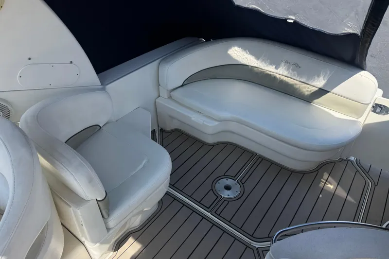 Slide: The Image of Interior seating of 2006 Sea Ray Sundancer 260 boat with cushioned seats and teak flooring. - 12