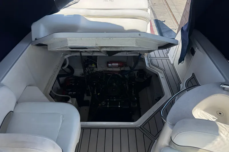 Slide: The Image of 2006 Sea Ray Sundancer 260 engine compartment with open hatch, showcasing interior details. - 13