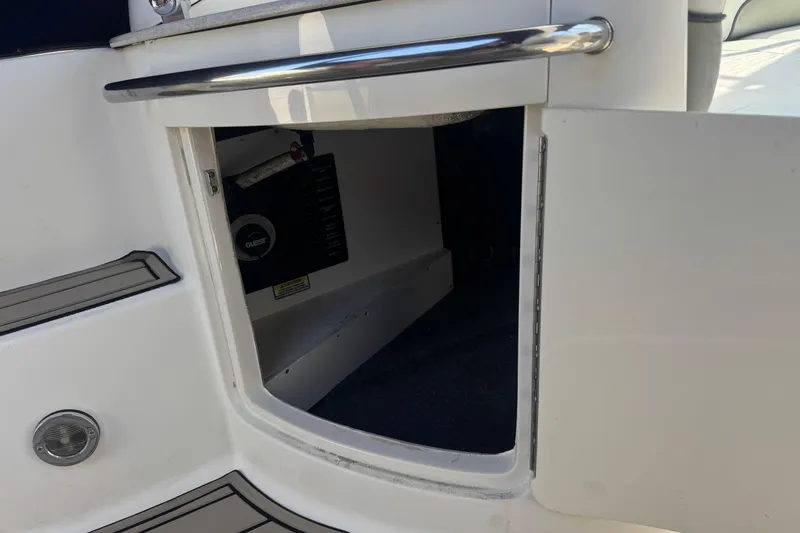 Slide: The Image of Open storage compartment on a 2006 Sea Ray Sundancer 260 boat. - 16