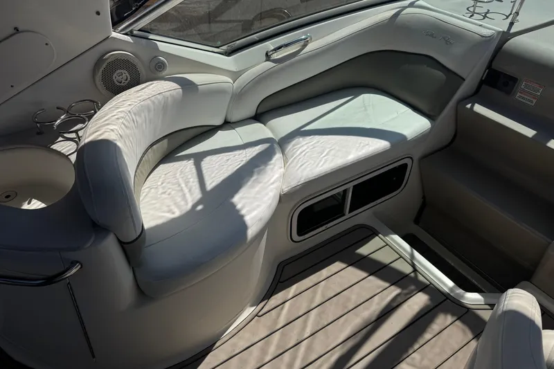 Slide: The Image of Interior seating of 2006 Sea Ray Sundancer 260 boat, featuring white leather upholstery. - 17