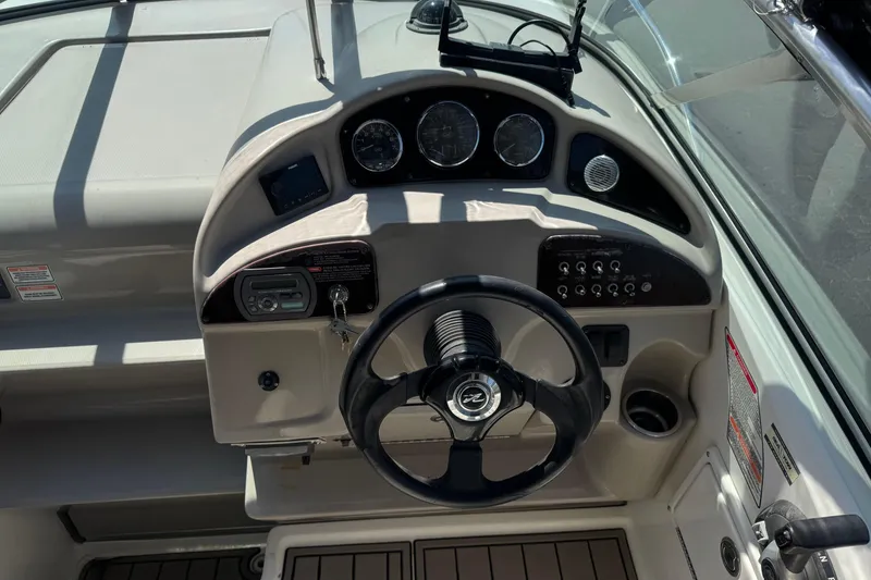 Slide: The Image of 2006 Sea Ray Sundancer 260 helm with steering wheel and instrument panel. - 19