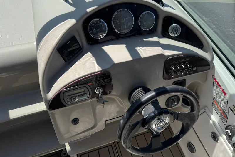 Slide: The Image of Dashboard of a 2006 Sea Ray Sundancer 260 boat with steering wheel and controls. - 20