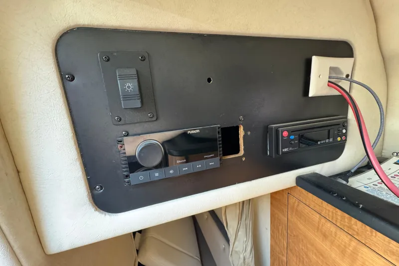 Slide: The Image of Control panel of a 2006 Sea Ray Sundancer 260 boat with electronic components. - 28